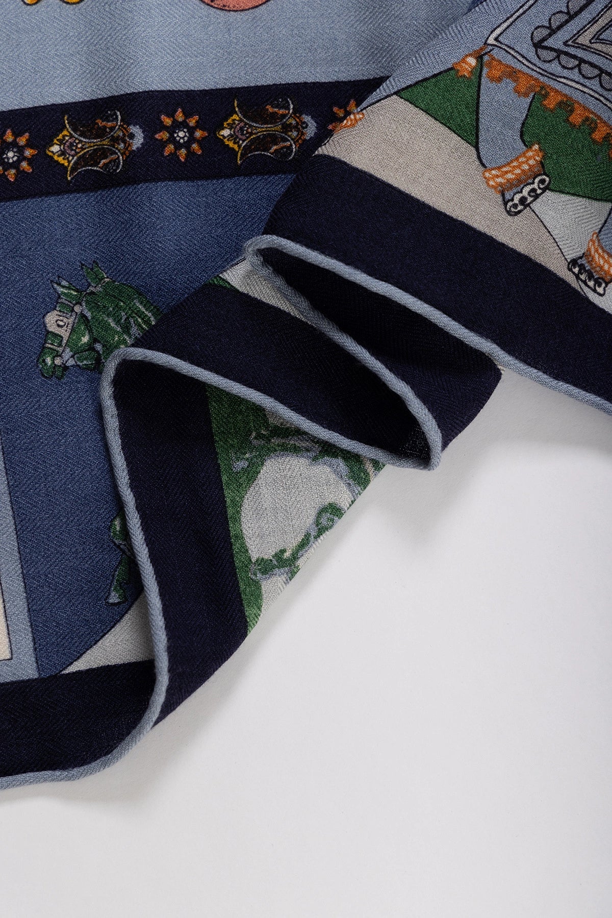 Silk Wool Square Scarf - Persimmon Tree Print | Blue, 130*130cm, close-up of folded edge, highlighting intricate floral and carriage motifs, elegant style.