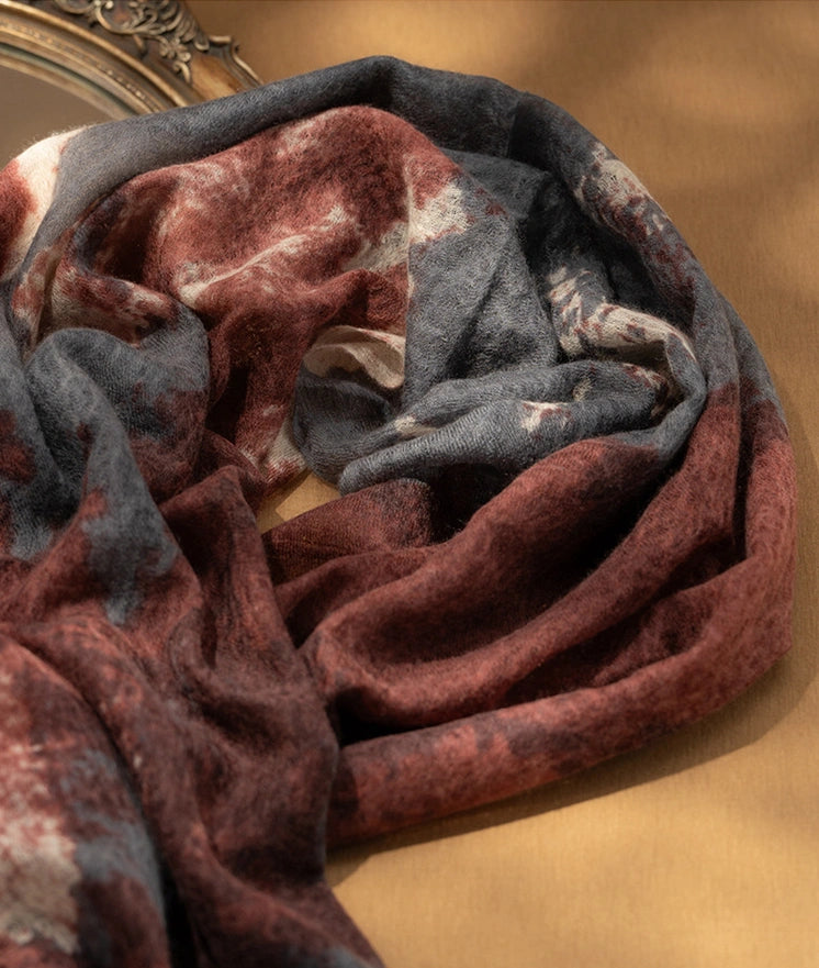 Detailed view of the burgundy cashmere scarf, showcasing its luxurious and soft cashmere material.
