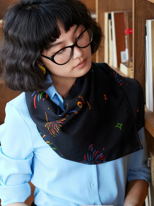 Black fireworks ballerina silk scarf styled as an elegant neck scarf with a blue shirt