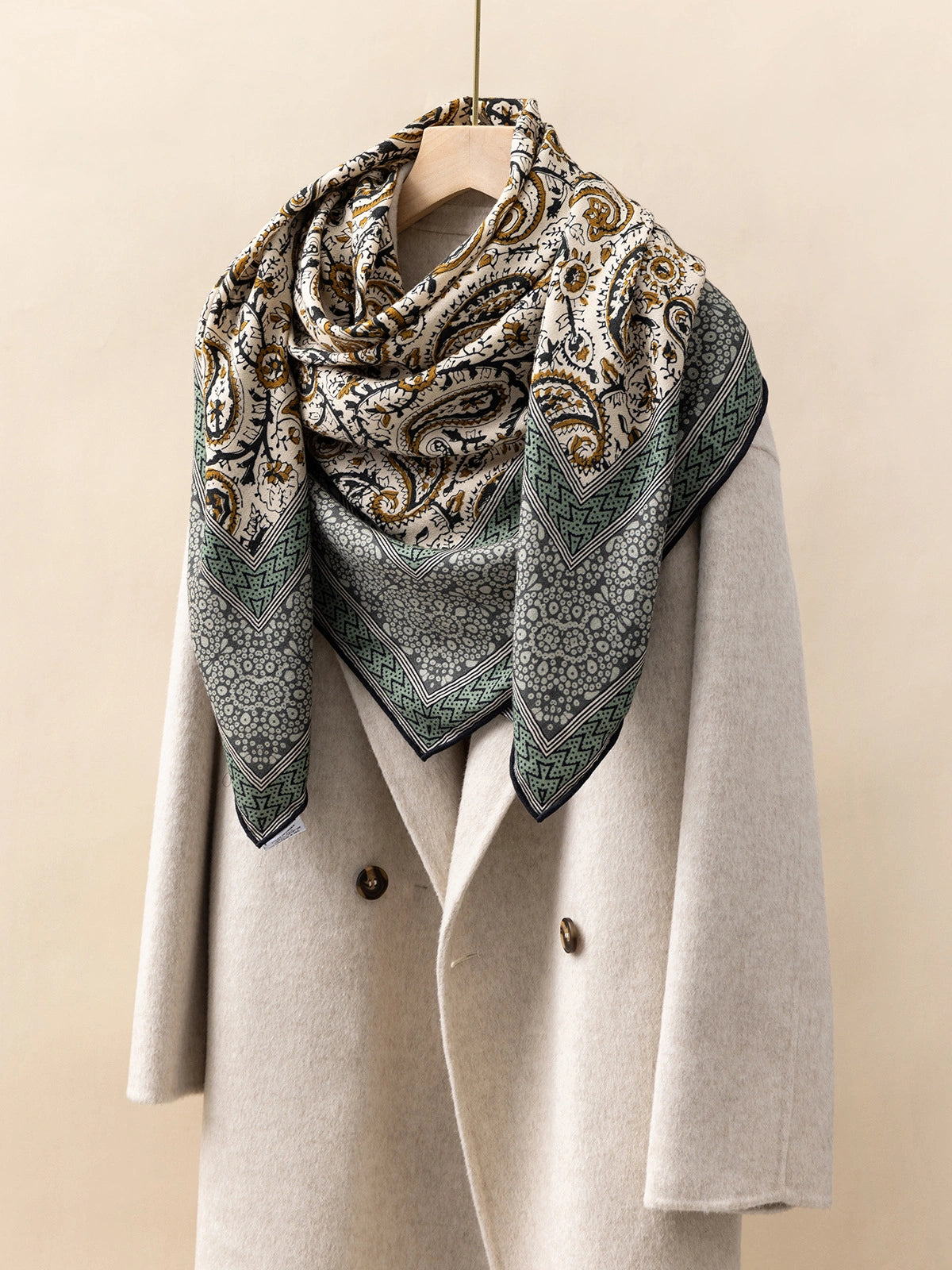 Silk Wool Square Scarf – Vintage Paisley Design | Green, 130*130cm, draped on a coat, highlighting intricate paisley patterns, elegant fashion accessory.