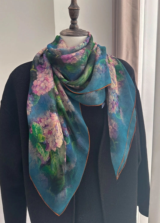 Green floral plant-dyed silk scarf wrapped around a mannequin for elegant styling