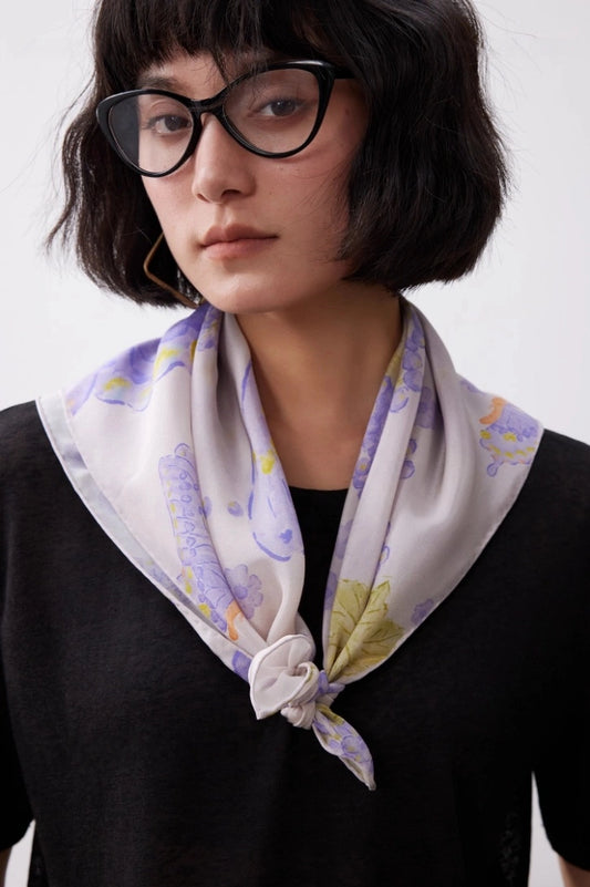 Purple butterfly silk square scarf tied as a neck scarf with a black top