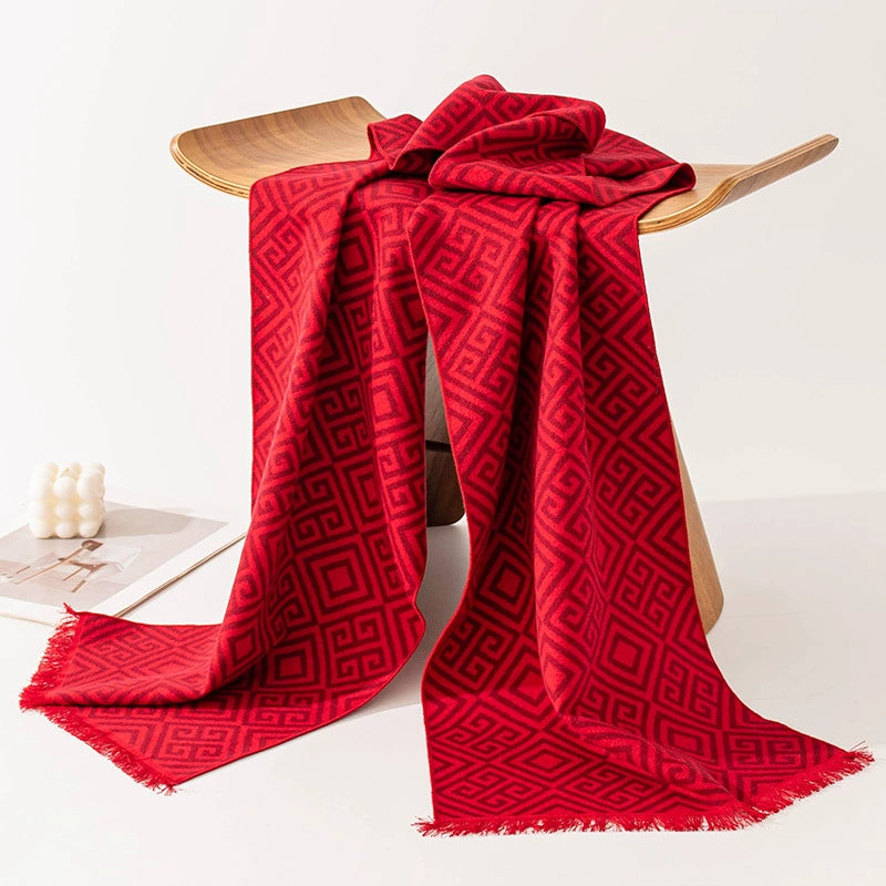 Red geometric brushed silk long scarf draped on a wooden hanger