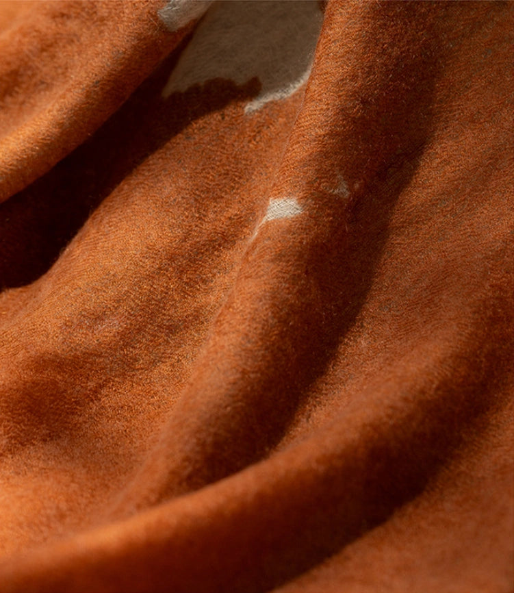A close-up look at the luxuriously soft cashmere material of this tangerine cashmere scarf.