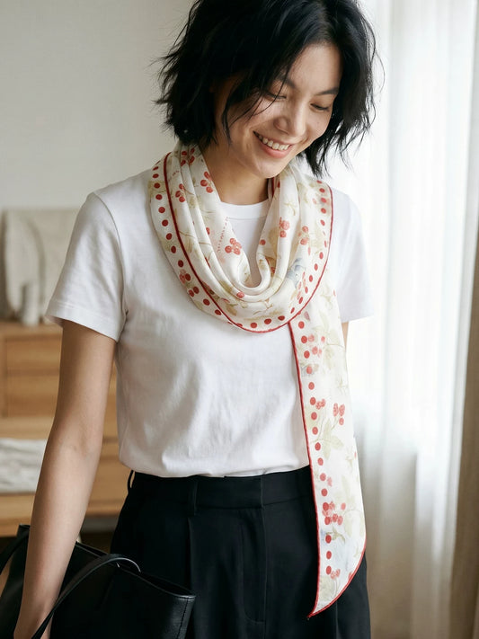 Woman styling a berry rabbit print mulberry silk scarf in a double-loop neck style