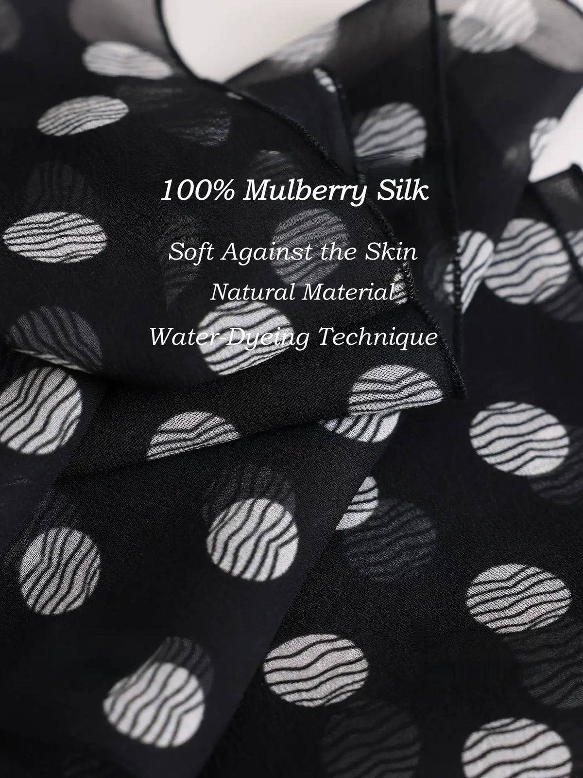 Close-up of black polka dot 100% mulberry silk georgette scarf with soft natural texture