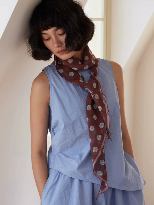 Brown polka dot skinny silk scarf tied at the neck, lightweight 100% mulberry silk georgette