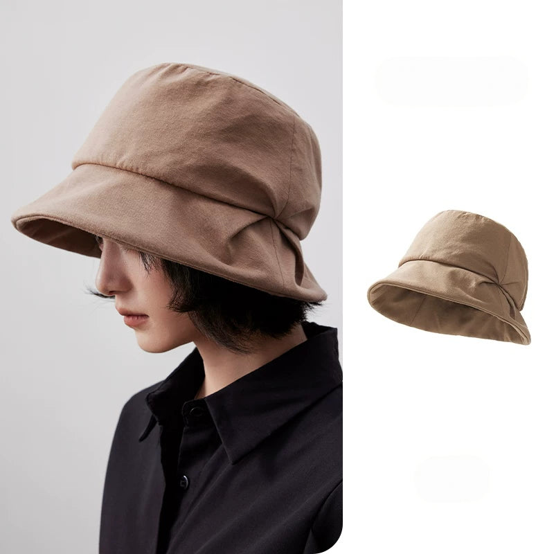 Camel artistic pleated bucket hat with sculpted folded brim, shown from the side with a separate product view