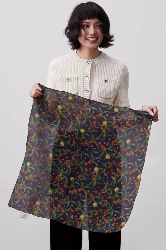 Dark blue osmanthus silk square scarf draped gracefully, emphasizing its smooth texture and timeless design.