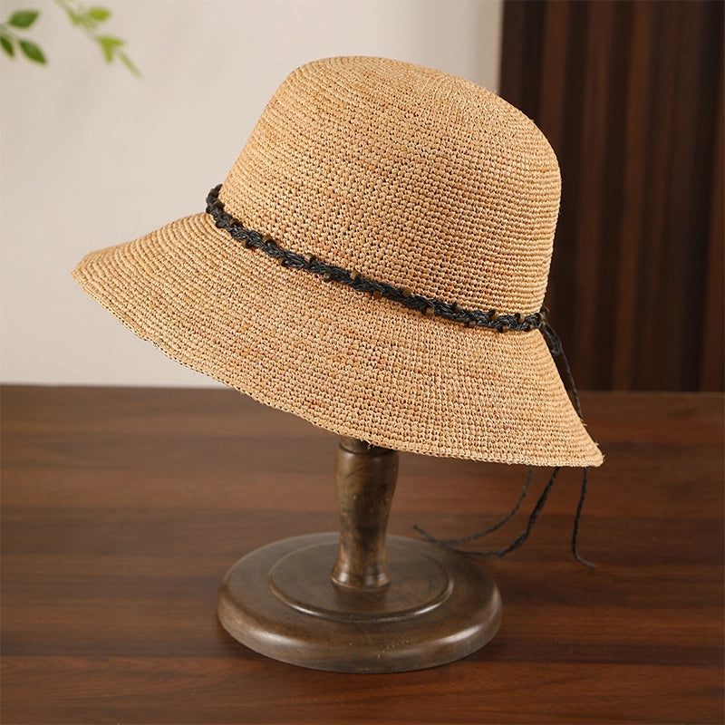Black bow wide brim raffia sun hat with crochet straw texture, ideal for beach holidays and daily sun protection.
