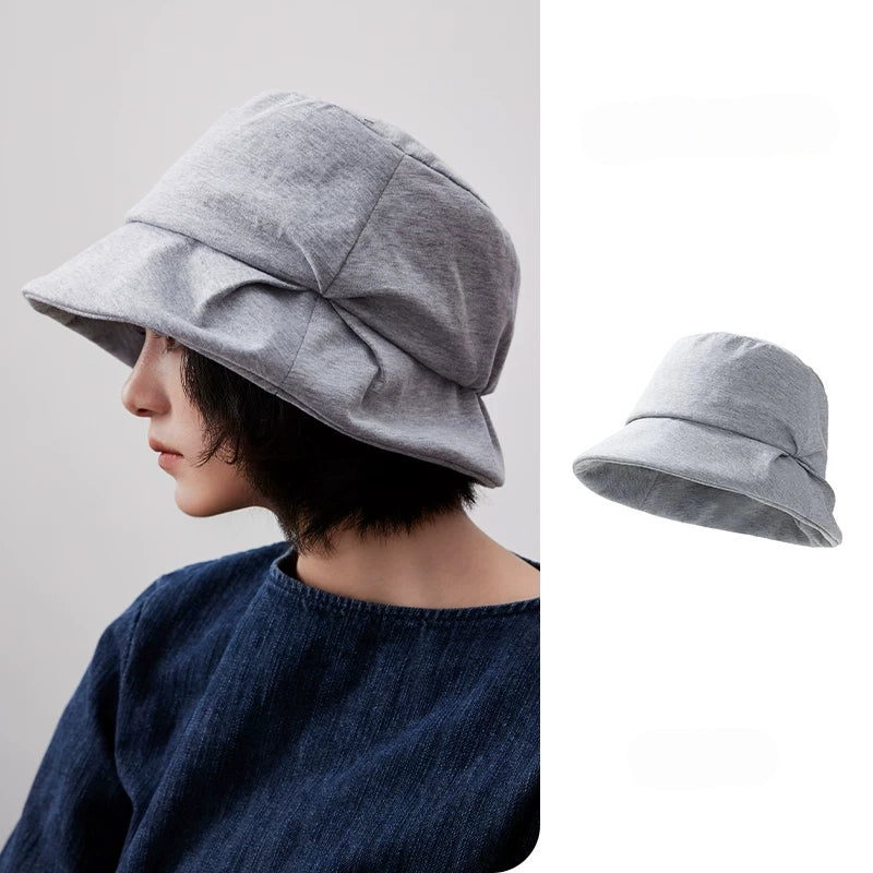 Heather gray artistic pleated bucket hat with folded brim, shown on a model with a separate product view