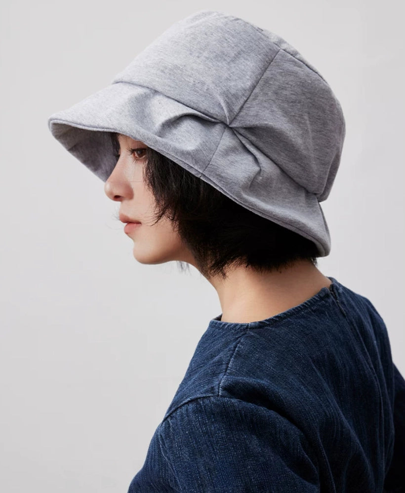 Rear side view of a heather gray pleated bucket hat showing its layered crown and downward brim