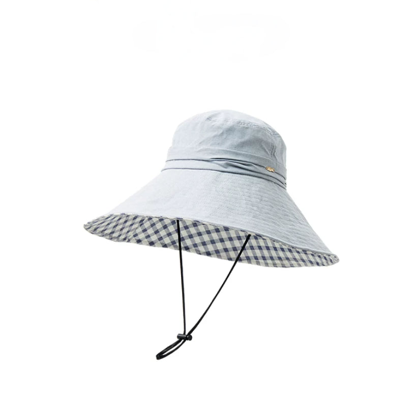 Light blue cotton wide brim sun hat with plaid lining, wind cord, and packable travel design