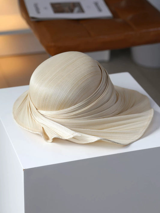 Natural Buntal straw wide brim sun hat with soft pleated draped brim.