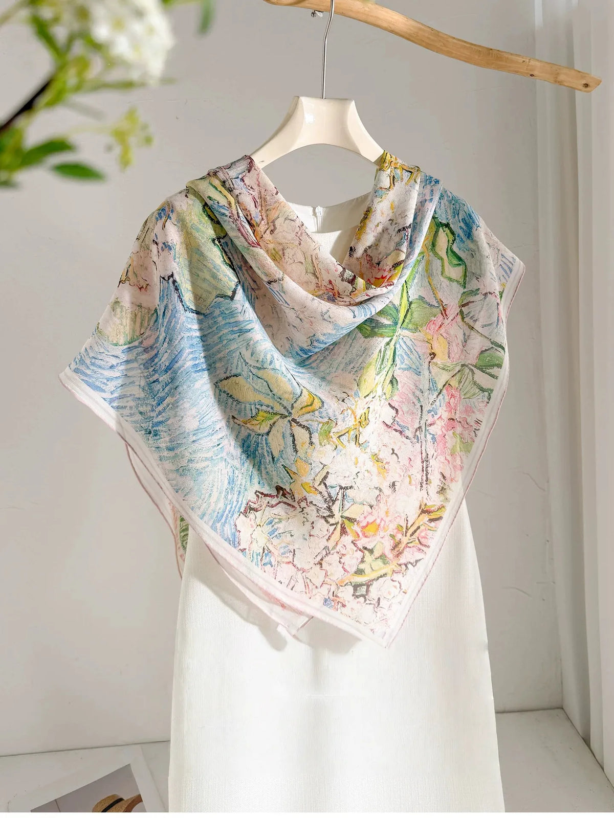 Large floral silk square scarf styled in a front triangle over a white dress