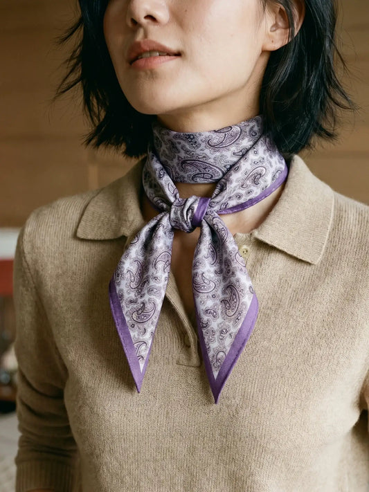 Purple paisley silk wool scarf wrapped around the neck with pointed ends