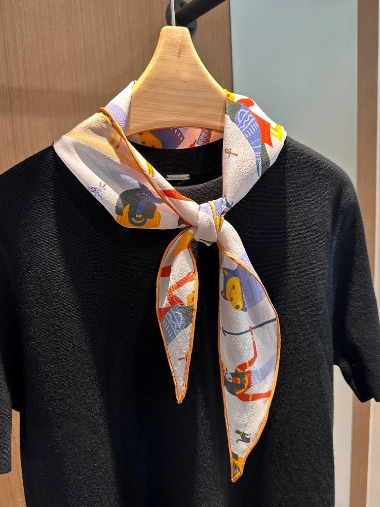 Tribal print silk scarf styled as a neck scarf on hanger, elegant mulberry silk accessory
