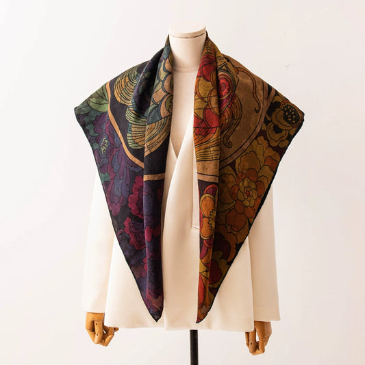 Xiangyun mulberry silk square scarf draped over a mannequin with an artistic twin fish and floral print