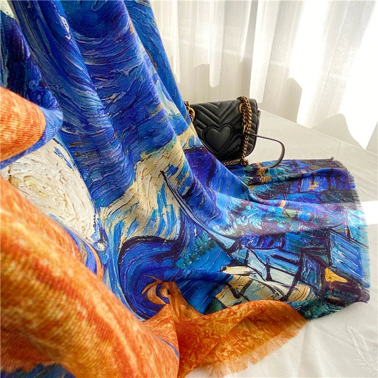 Large Starry Night wool scarf draped beside a black handbag, highlighting its fluid blue and orange art print