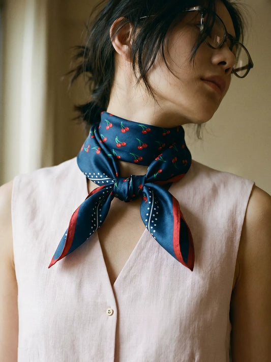 Navy cherry print silk neckerchief styled with a sleeveless neutral top