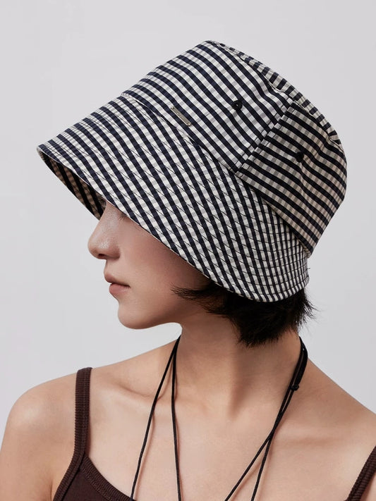Side view of black and white plaid ponytail bucket hat with structured wide brim