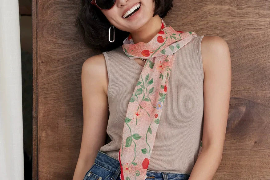 Woman wearing lightweight silk scarf in elegant summer outfit