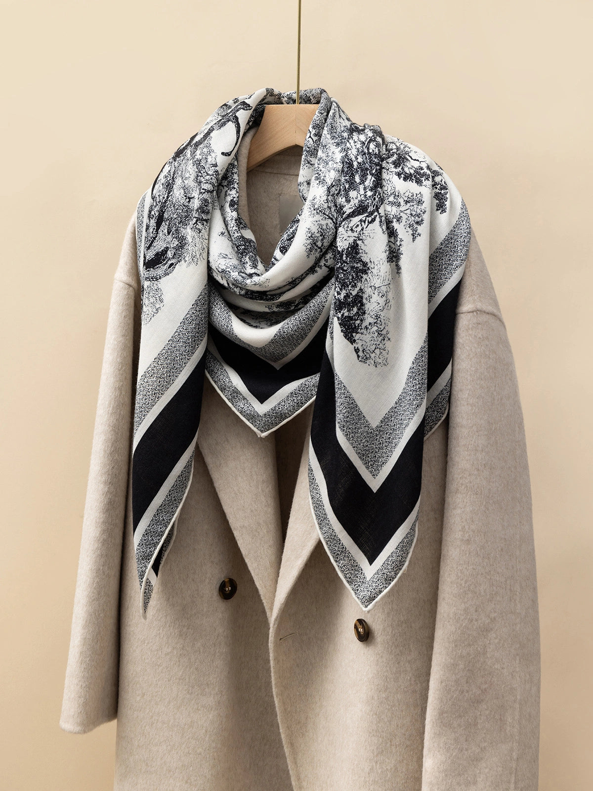 Silk Wool Square Scarf - Animal Jungle Print | Black, 130*130cm, draped on a coat, showcasing vibrant jungle pattern, stylish and luxurious accessory. 