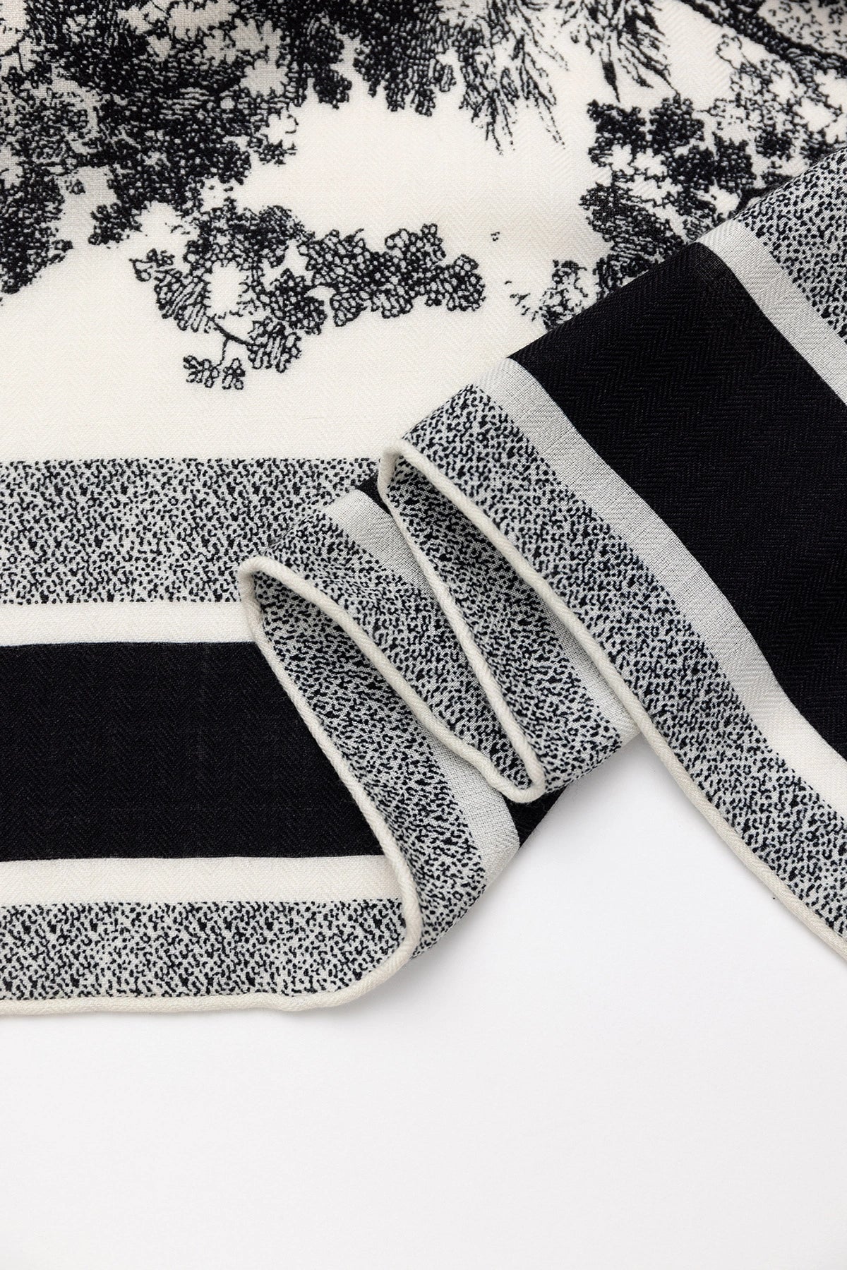 Silk Wool Square Scarf - Animal Jungle Print | Black, 130*130cm, close-up of edge, showcasing intricate jungle motifs, luxurious scarf.  