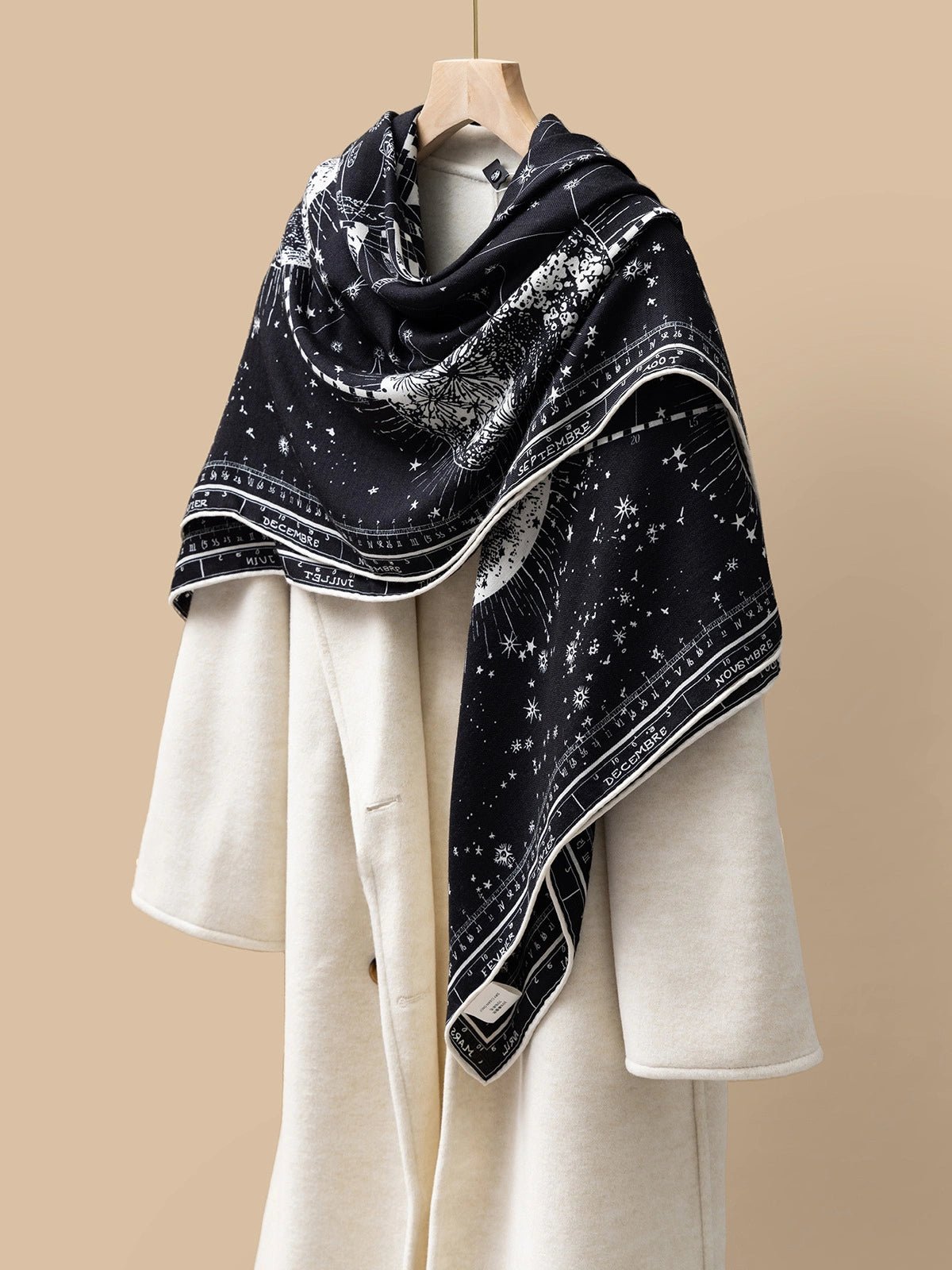 Silk Wool Square Scarf - Cosmic Star Map Print | Black, 130*130cm, angled on coat, highlighting star and moon motifs, elegant fashion statement.