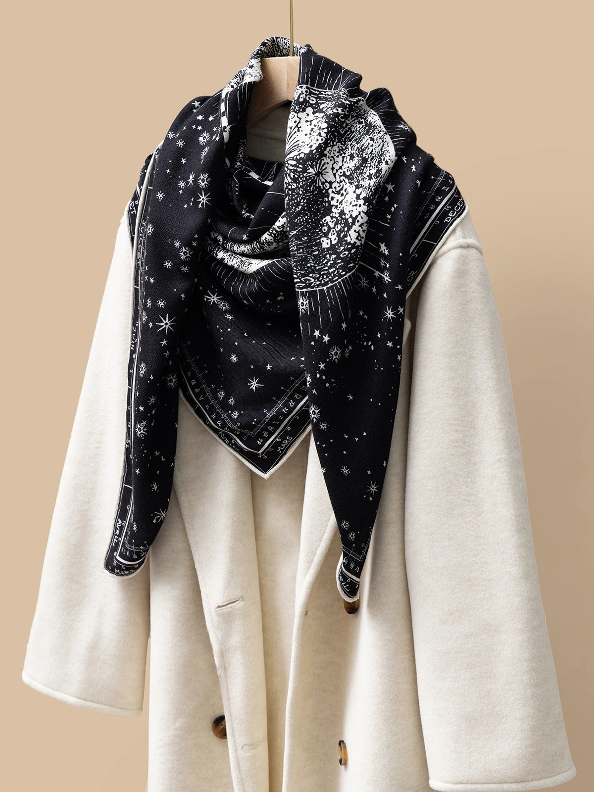 Silk Wool Square Scarf - Cosmic Star Map Print | Black, 130*130cm, draped on a coat, showcasing starry map pattern, stylish and luxurious accessory. 