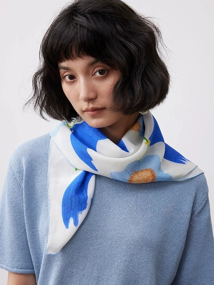 Elegant blue bird flower silk scarf styled as a neck scarf with a blue top