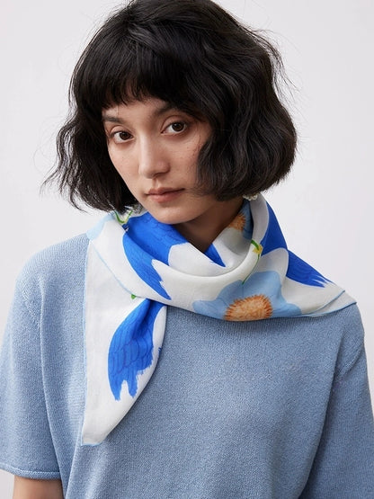 Elegant blue bird flower silk scarf styled as a neck scarf with a blue top