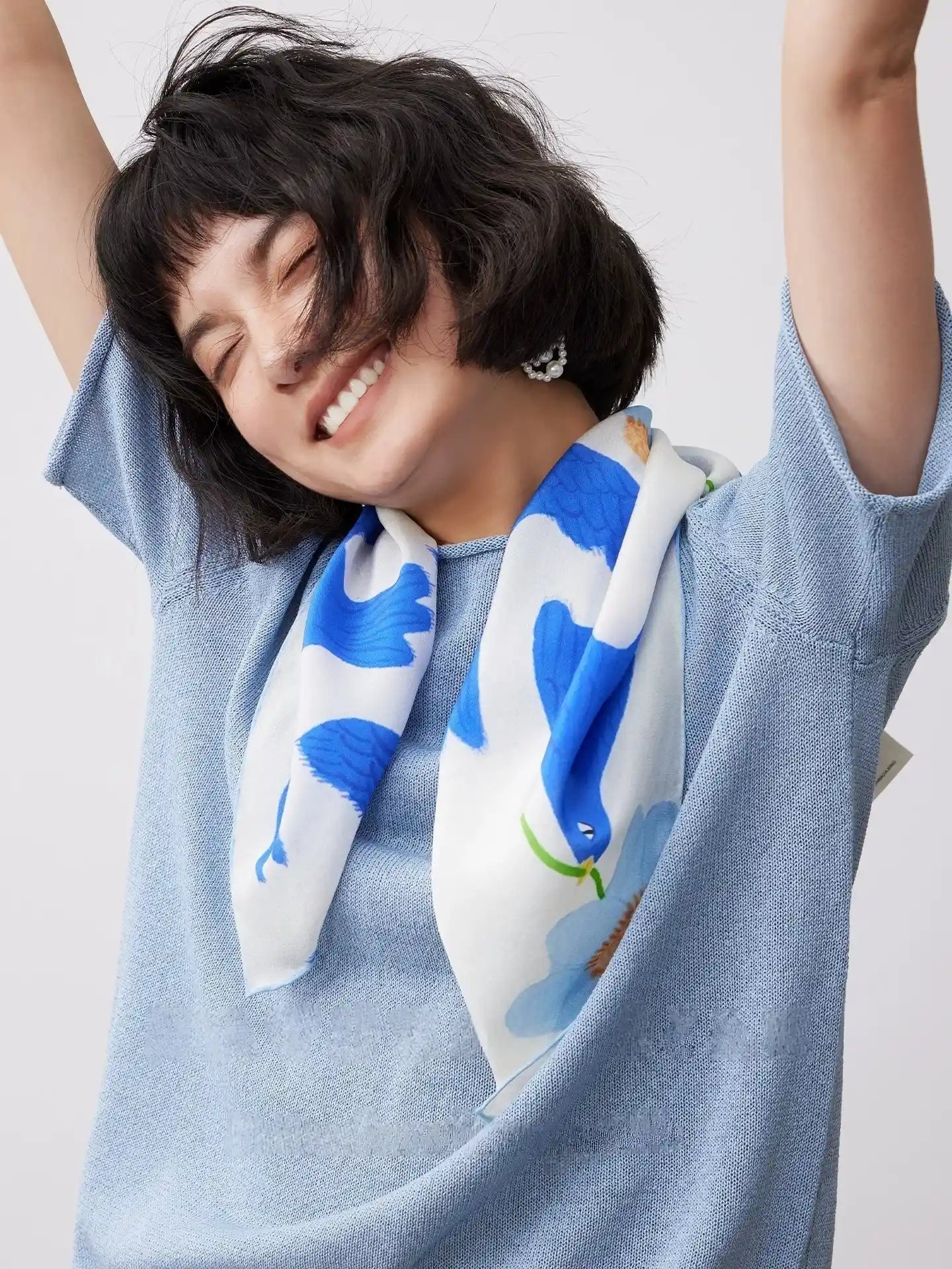 Blue bird flower print silk square scarf worn as a soft neck scarf for everyday elegance