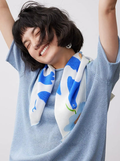 Blue bird flower print silk square scarf worn as a soft neck scarf for everyday elegance
