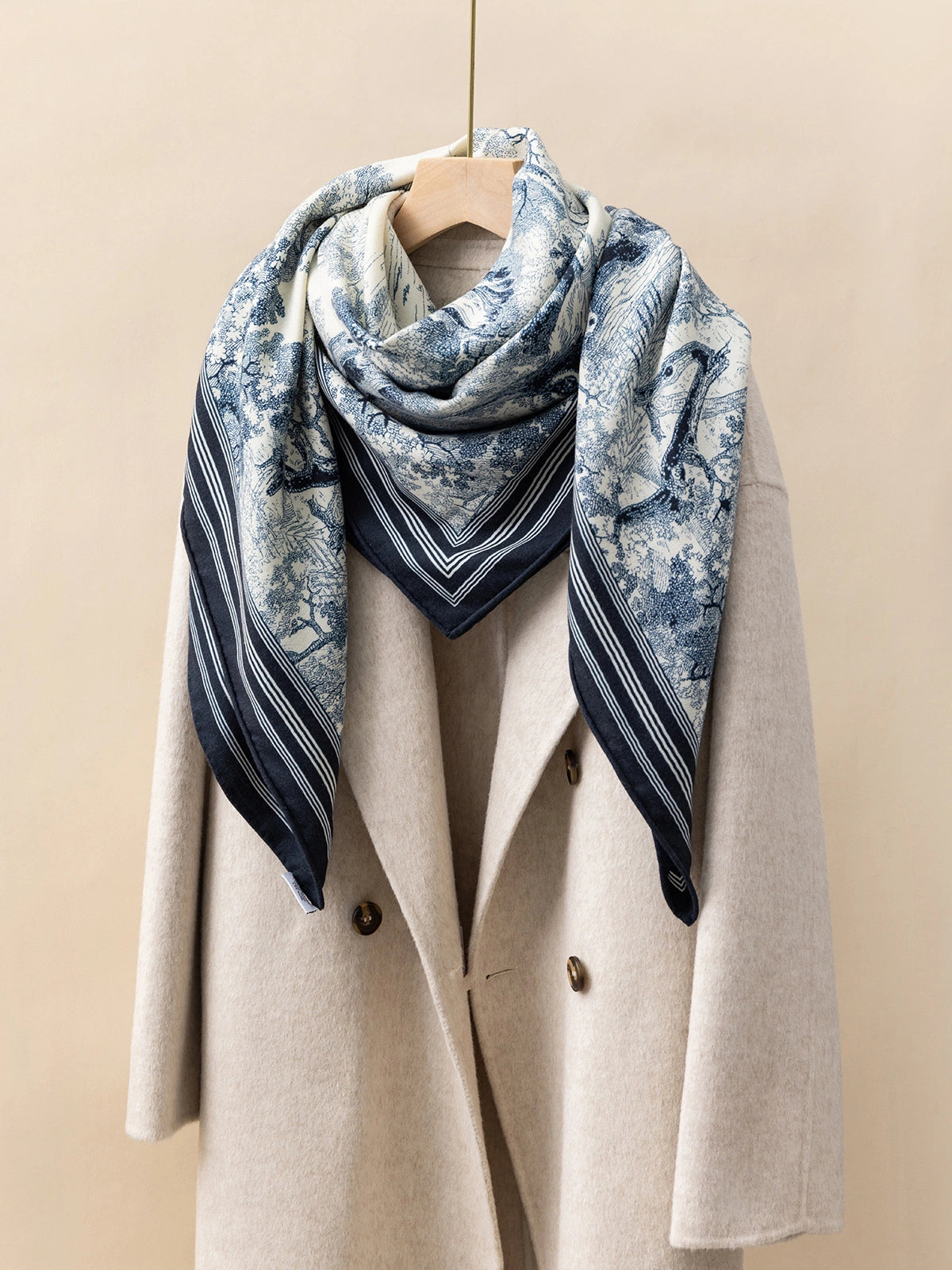 Silk Wool Square Scarf - Animal Jungle Print | Blue, 130*130cm, angled on coat, highlighting jungle animal motifs, elegant fashion statement.  