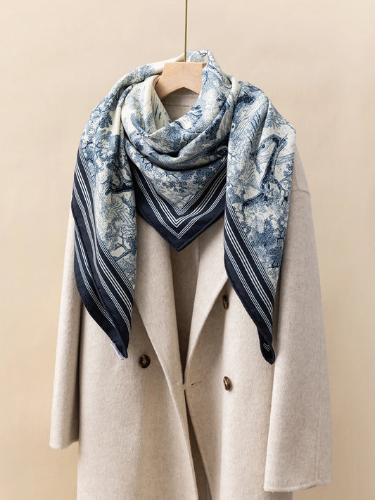 Silk Wool Square Scarf - Animal Jungle Print | Blue, 130*130cm, angled on coat, highlighting jungle animal motifs, elegant fashion statement.  