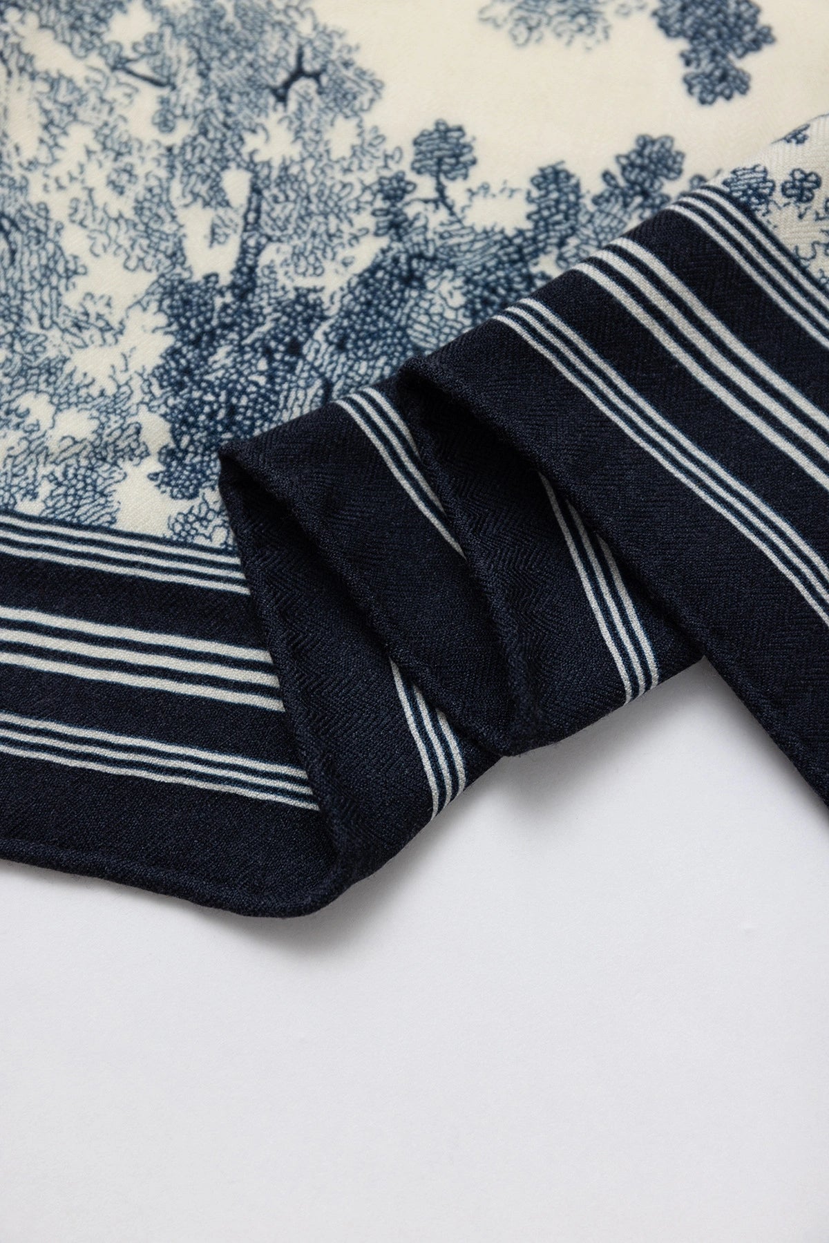 Silk Wool Square Scarf - Animal Jungle Print | Blue, 130*130cm, close-up of edge, showcasing intricate jungle motifs, luxurious scarf.  