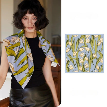 Blue tulip floral mulberry silk square scarf styled around the neck with matching flat lay detail