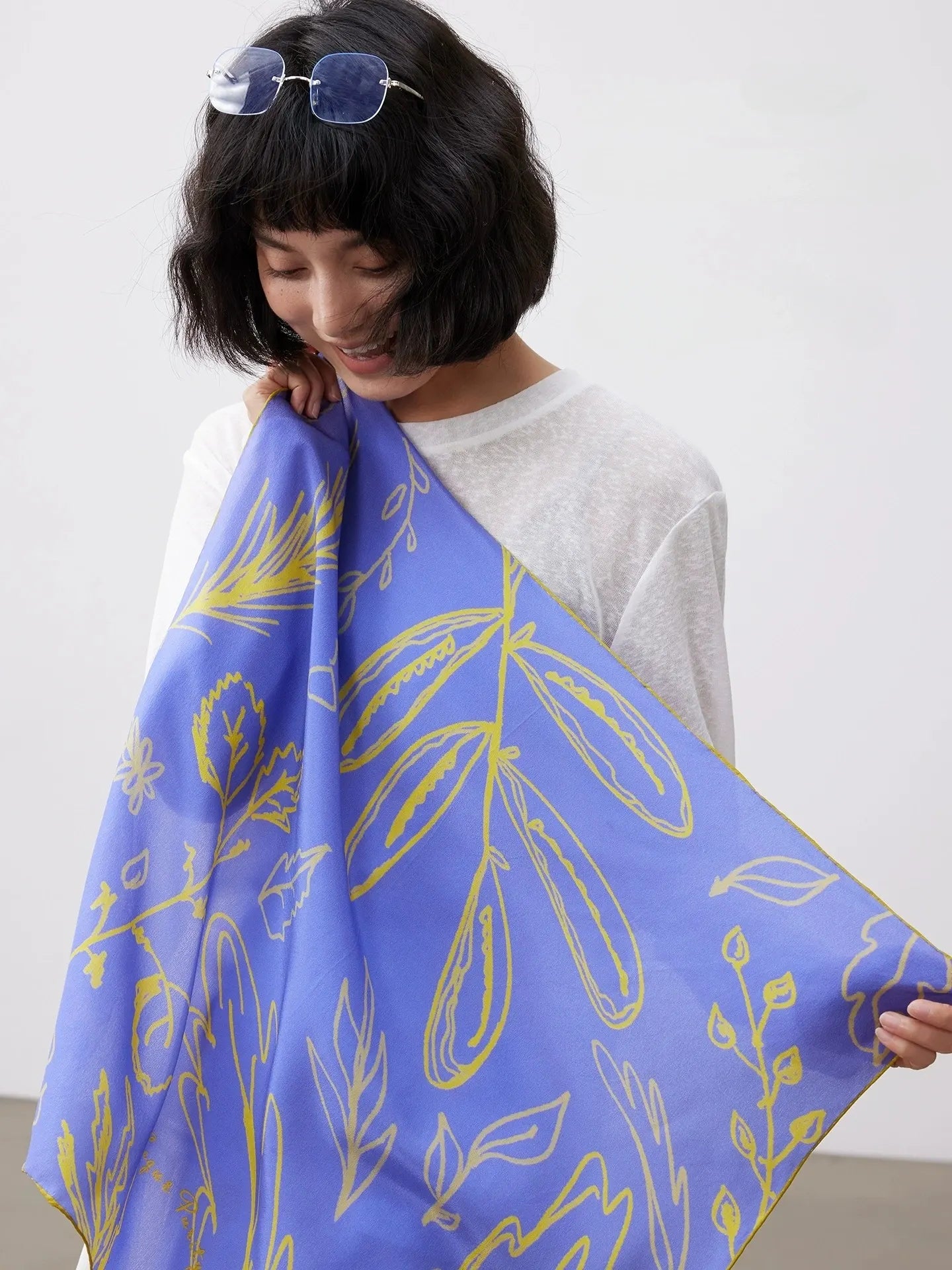 Blue mulberry silk square scarf displayed open to show the elegant botanical print