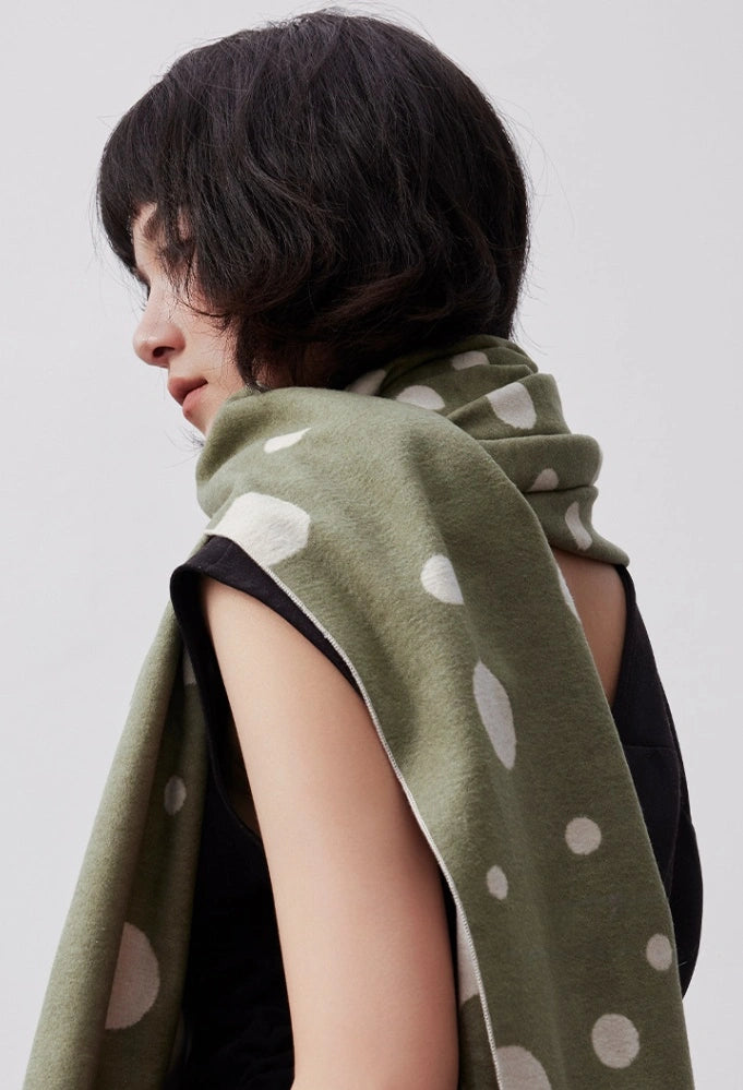 Olive green brushed silk wrap styled over the shoulder for a refined winter outfit
