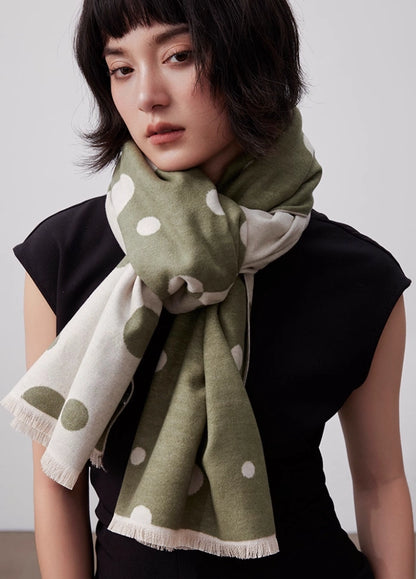 Olive green large brushed silk scarf worn as a soft neck wrap with white polka dot pattern