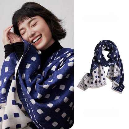 Navy blue brushed silk scarf with ivory geometric pattern wrapped around the shoulders