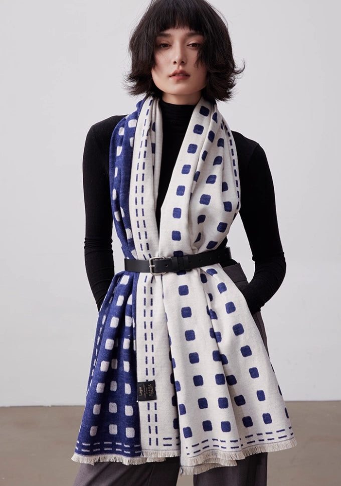 Model wearing a navy and ivory brushed silk scarf as a belted wrap for elegant winter styling