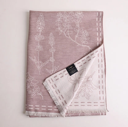 Folded pale pink mulberry silk scarf with white floral line art print and brushed silk finish