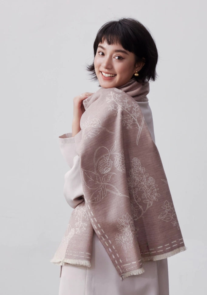 Model wearing a pale pink brushed silk wrap with white floral print for an elegant romantic look