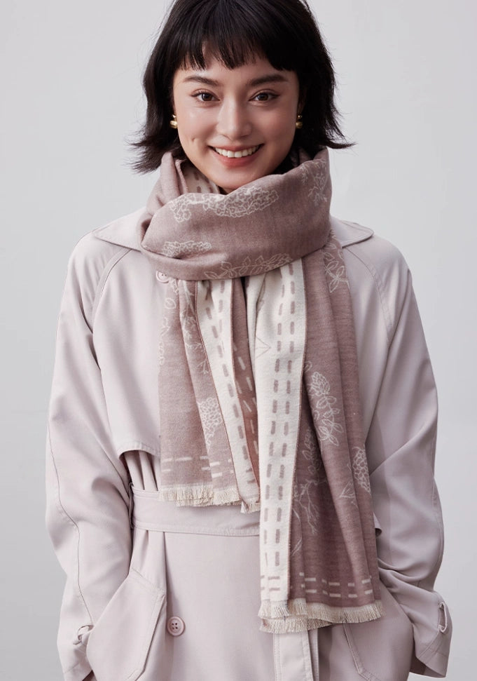 Model wearing a pale pink large brushed silk scarf in 100% mulberry silk with a soft cashmere-like finish