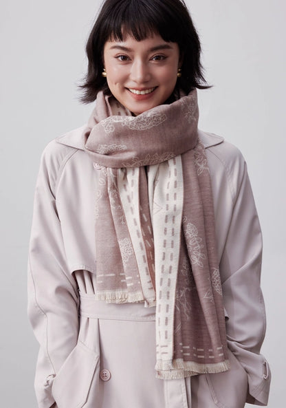 Model wearing a pale pink large brushed silk scarf in 100% mulberry silk with a soft cashmere-like finish