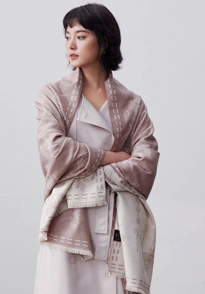 Model wearing a pale pink brushed silk wrap for women over a white outfit for elegant winter styling