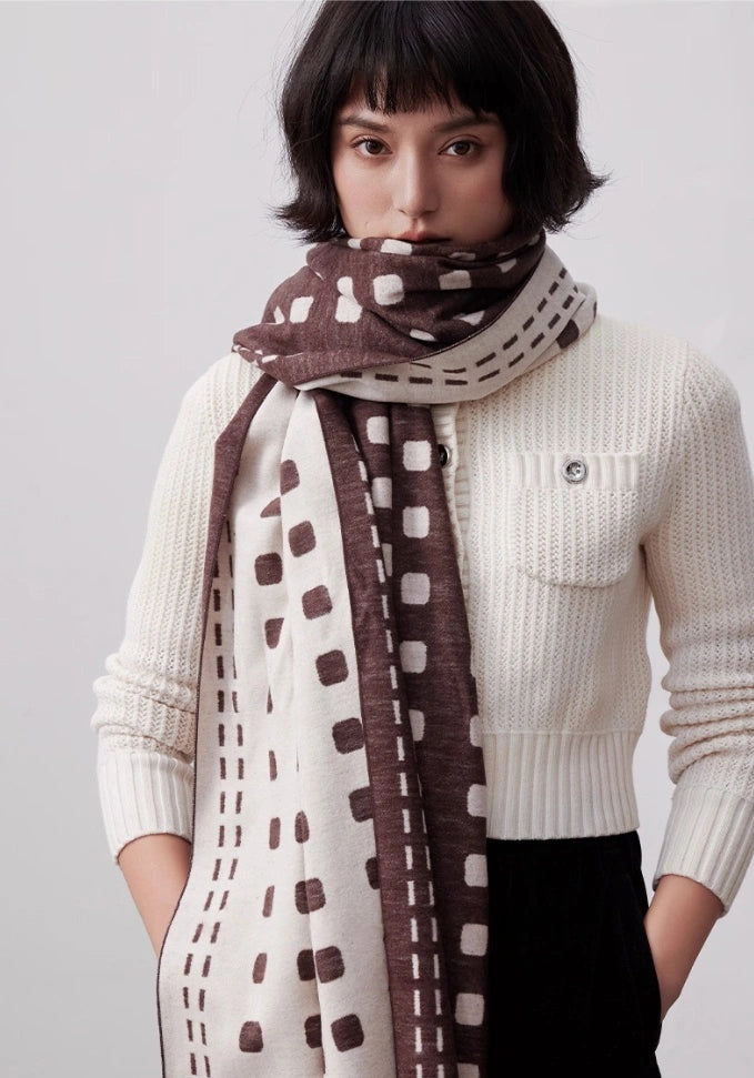 Brown brushed silk scarf styled as a cozy neck wrap with soft cashmere-like texture and ivory pattern
