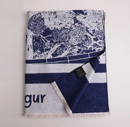 Folded navy blue brushed silk scarf with artistic abstract print, soft fringed edge, and mulberry silk texture
